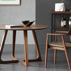 a wooden table with two chairs and a bowl on top of it in a living room