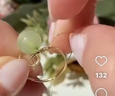 a person is holding a ring with a flower in the background and text that reads, i love you