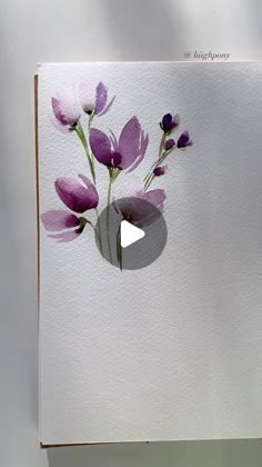 a white card with purple flowers on it