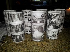 several cups with pictures on them sitting on a counter