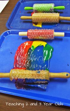 three plastic trays filled with different colored popsicles