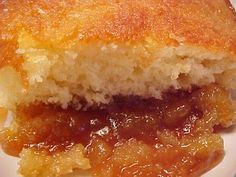 a close up of a piece of cake on a plate with fruit preserves in the middle