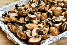 a pan filled with sliced mushrooms on top of aluminum foil