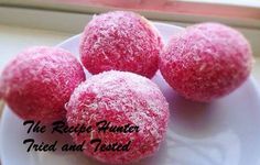 three pink donuts sitting on top of a white plate next to a windowsill