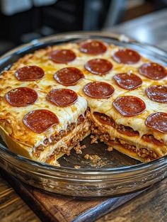 a pizza sitting on top of a metal pan covered in cheese and pepperoni slices