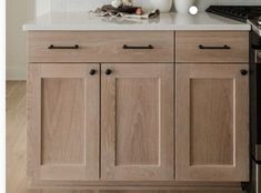 a kitchen with wooden cabinets and white counter tops