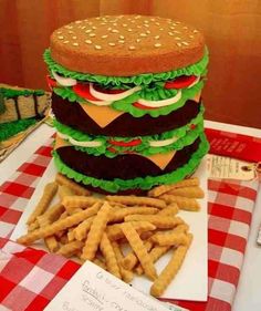 a giant hamburger and fries on a table with the caption, cool cake?