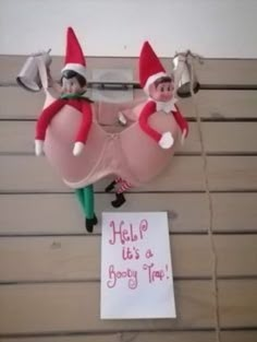 two elfs hanging from the side of a wall