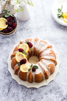 a bundt cake with lemons and raspberries on top