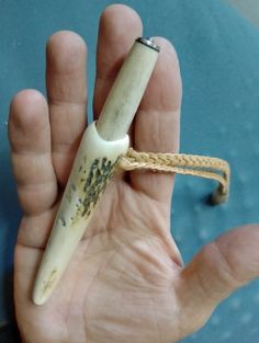 a hand holding an old toothbrush in it's palm with writing on it