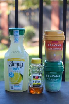 the ingredients to make an ice cream smoothie sit on a wooden table outside in front of a fence