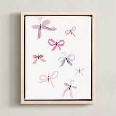 an art piece with pink and purple bows on it