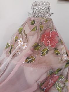 a pink scarf with flowers and leaves on it