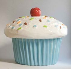 a cupcake with white frosting and sprinkles on top is shown