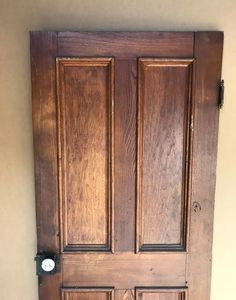 an old wooden door with two sidelights and knobs on the bottom half of it