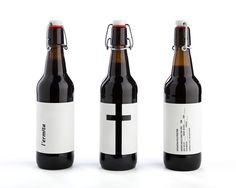 three black and white beer bottles with a cross on them