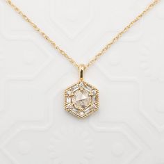 "Can be purchased as a pendant charm only or with rope chain necklace. Earth mined natural rose cut diamond necklace set in art deco inspired hexagon setting using baguette and round brilliant diamonds. Hexagon charm size: 9.5mm wide Approx. 0.14ct white accent diamonds Made of recyclable solid gold and ethically sourced gemstones If purchased as a necklace, comes with a rope chain with adjustable lengths at 18\" and 20\"." Luxury Teardrop Pendant Necklace With Rose Cut Diamonds, Art Deco Pendants, Art Deco Pendant Jewelry With Single Cut Diamonds, Art Deco Single Cut Diamond Pendant Jewelry, Art Deco Single Cut Diamond Pendant, Art Deco Style Single Cut Diamond Pendant, Art Deco Necklace With Single Cut Diamonds As Gift, Art Deco Necklace With Single Cut Diamonds For Gift, Art Deco White Gold Necklace With Rose Cut Diamonds