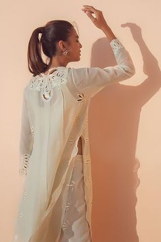 Crafted from ivory-colored khaddi corduroy, this classic silhouette is finished with a tassel and eyelet embroidery detailing. Complete the look with our signature ivory Panwars. Pakistani Cutwork Suits, Cutwork Suits, Eid Collection 2022, Cutwork Dress, Sania Maskatiya, Eid Fashion, Casual Embroidery, Lace Dress Design, Kurti Embroidery Design