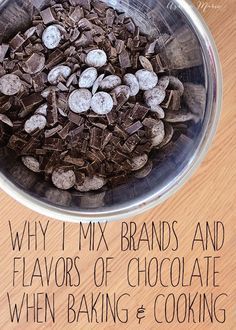 a metal bowl filled with chocolate chips on top of a wooden table next to a sign that says, why i mix brands and flavors of chocolate when baking & cooking