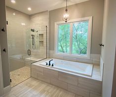 a bathroom with a large tub and walk in shower