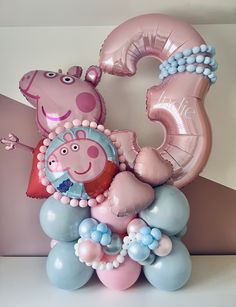 some balloons that are in the shape of numbers and animals on top of each other