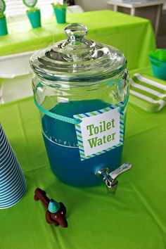 a table topped with a jar filled with blue liquid