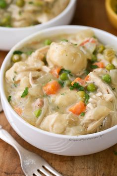 a white bowl filled with dumplings and vegetables