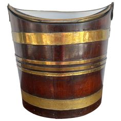 an old wooden barrel with gold stripes on it