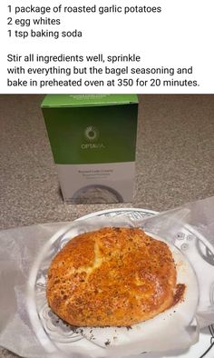 a piece of bread sitting on top of a white plate next to a green box