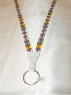 a close up of a key chain on a mannequin necktie with a metal ring