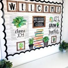 a bulletin board with succulents and books on it that says, welcome