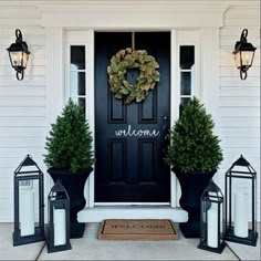 an instagram page with two black lanterns and a wreath on the front door