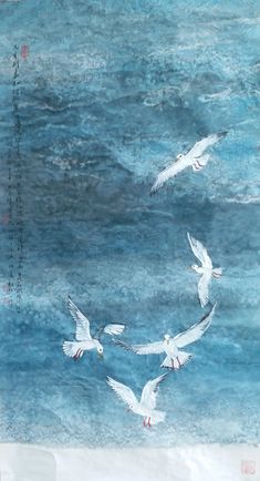 three white birds flying over the ocean with chinese writing on it's back ground