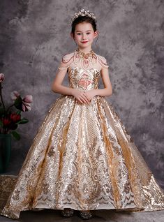 Time to give a life to your little girl's most awaited dream of a princess gown. This gold sequins knee length frock is the perfect manifestation of what a royal gown looks like. Shimmering and twinkling with all its might, this gold frock starts off with a high neck design that too embellished with red, gold and white beads. Cap sleeves make up a beautiful addition as it successfully amplifies the overall feel of the gown. Lace up back with a long elliptical cut out looks all the more ravishing Sequin Flower Girl Dress, Girl Frock, Aesthetic Baby, Princess Flower Girl Dresses, Dresses Tulle, All Black Dresses, Golden Dress, Baby Ootd, Girls Frock Design