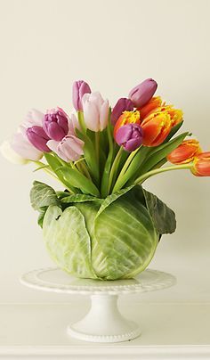 a vase filled with lots of colorful flowers