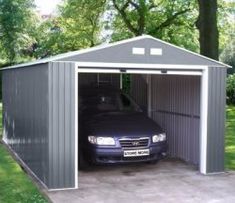 a car is parked in the garage with its door open