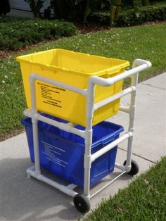 a yellow and blue cart sitting on top of a sidewalk