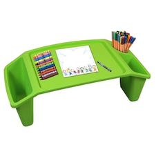 a green desk with markers, pencils and paper on it in front of a white background