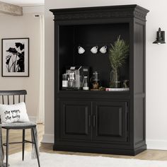 a living room with a black cabinet and white rug