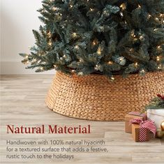 a christmas tree in a woven basket with presents under it and the words natural material