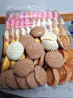 a plastic bag filled with lots of different types of cookies on top of a table