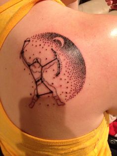 a woman with a tattoo on her back that has dots in the shape of an elephant