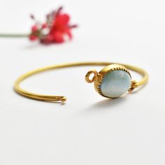 Larimar Gold Plated Bangle, Natural Larimar Oval Bangle, 925 Sterling Silver Gold Plated Bangle, Handmade Openable Bangle, Gift For Her  Stone - Larimar Stone Size - 12x16 mm Stone Shape - Oval Materiel - 925 Sterling Silver  Metal Color  -  Gold Plated ------------------------------------------- Discover the serene beauty of the ocean encapsulated in our Ocean Whisper Larimar Bangle. Designed for the modern connoisseur, this exquisite bangle combines the tranquil charm of larimar with the timel Elegant Amazonite Bracelets As A Gift, Larimar Bracelet Jewelry Gift, Elegant Amazonite Gemstone Bracelets, Handmade Adjustable Larimar Bracelets, Elegant Larimar Bracelet Jewelry, Elegant Turquoise Larimar Bracelets, Gold Plated Bangles, Unique Gemstones, Silver Gold