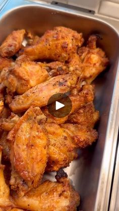 chicken wings sitting in a pan on top of a counter