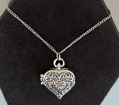 "Featuring this pretty silver tone Bali-style heart locket pendant necklace.  The Locket has a magnetic closure and measures 1-1/16\" x 15/16\".  It hangs on an adjustable chain measuring from 26\"-29\".  The necklace is in very good vintage condition." Silver Double Heart Locket Necklace With Heart Charm, Silver Metal Heart Necklace Engraved, Silver Open Heart Locket Necklace With Heart Charm, Engraved Silver Heart Necklace, Silver Engraved Heart Necklace, Silver Heart Locket Necklace For Valentine's Day, Adjustable Heart Pendant Locket Necklace, Silver Locket Necklace With Adjustable Chain For Keepsake, Valentine's Day Silver Heart Locket Necklace