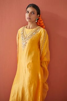 Yellow hand embroidered kurta crafted in chanderi tissue base. Paired with coordinating pant and four side embroidered organza dupatta. 
Component: 3
Pattern: Hand Embroidered 
Type Of Work: Pearl,Sequin,Floral
Neckline: Round Neck
Sleeve Type: Three Quarter Sleeve
Fabric: Chanderi Tissue,Organza
Color: Yellow
Other Details: 

Sequin and cutdana embellished floral pattern
Pearl embellished lace dupatta
Occasion: Puja,Mehendi and Haldi - Aza Fashions Festival Tissue Silk Straight Kurta, Embroidered Straight Kurta In Tissue Silk, Embroidered Tissue Silk Straight Kurta, Diwali Tissue Silk Kurta With Chikankari Embroidery, Navratri Embroidered Tissue Silk Kurta, Navratri Tissue Silk Kurta With Embroidery, Navratri Tissue Silk Kurta Embroidered, Yellow Tissue Silk Kurta With Zari Work, Anarkali Tissue Silk Kurta With Dori Work