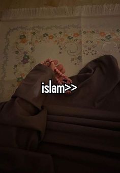 a person laying on top of a bed under a blanket with the word islam in front of them