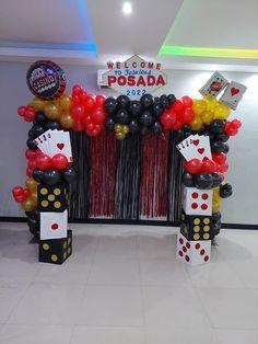 a casino themed birthday party with balloons and streamers on the front entrance to an event