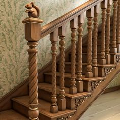 a wooden stair case with a squirrel statue on the top and bottom handrails