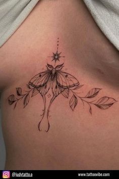 a woman's stomach with a flower tattoo on her chest and the bottom part of her breast